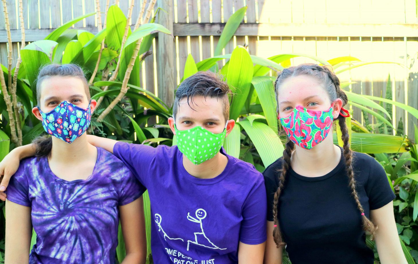 Three girls wearing handmade cloth face masks - the Three Masketeers