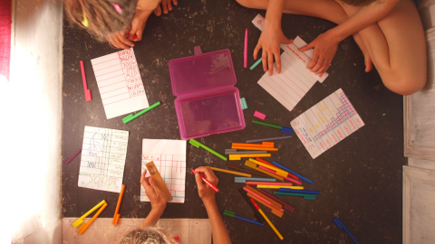Girls creating homeschool checklists